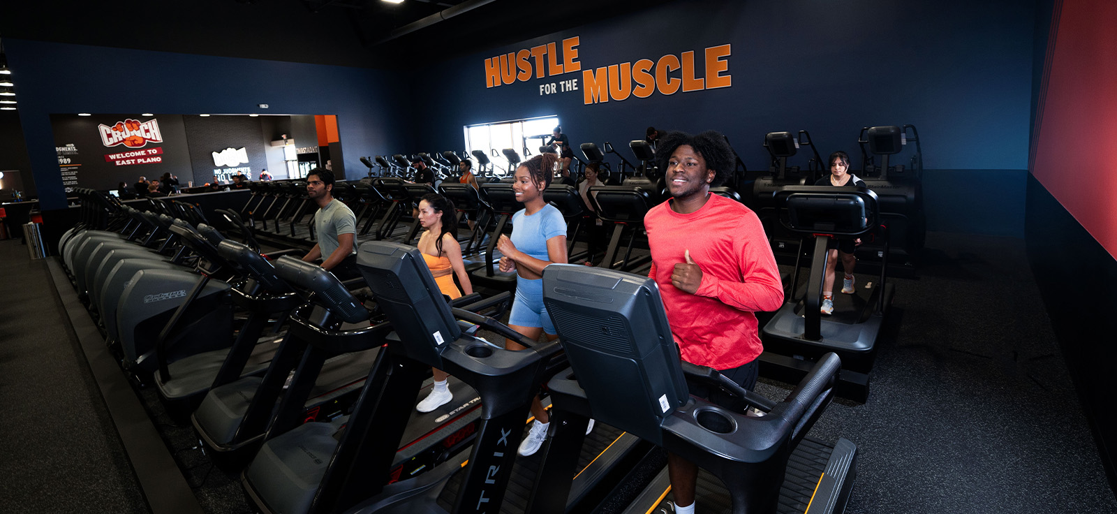 people on a treadmill at a crunch gym